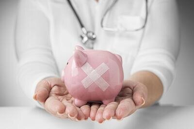 freepik-person-holding-piggy-bank-with-band-aids